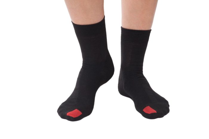 plus12socks Socken schwarz an Erwachsenen Füssen Vorderansicht